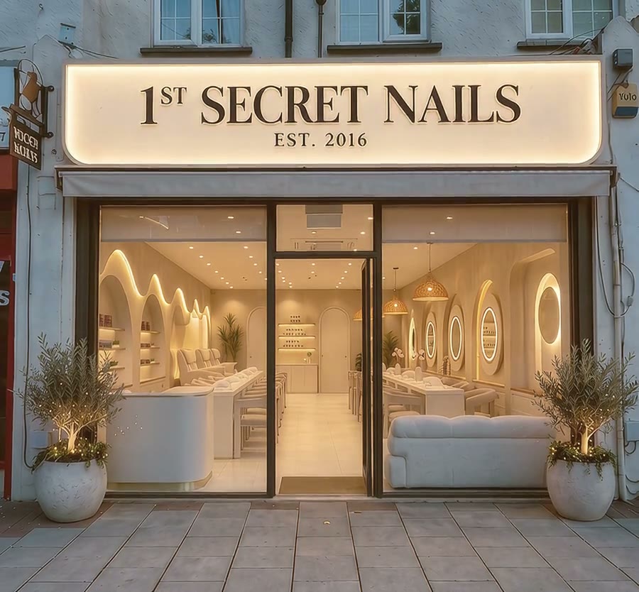 The 1st Secret Nails shopfront on Well Hall Road, Eltham, lit at dusk
